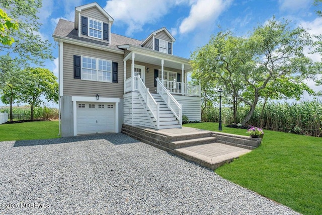 27 Main St, Port Monmouth, NJ 07758 - raised beach house with stairway, a porch, a garage, driveway, and a front lawn