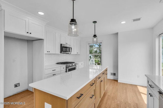 27 Main St, Port Monmouth, NJ 07758 - kitchen with appliances with stainless steel finishes, healthy amount of natural light, light wood finished floors, light countertops, and recessed lighting