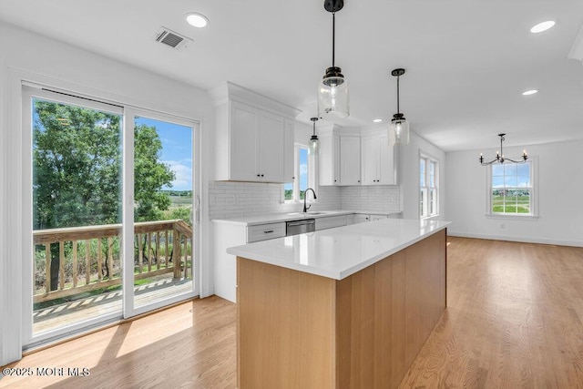 27 Main St, Port Monmouth, NJ 07758 - kitchen featuring a sink, light countertops, white cabinetry, dishwasher, and light wood-type flooring