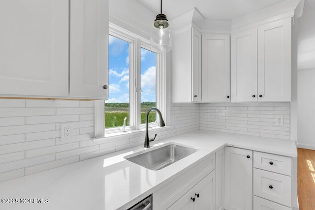 27 Main St, Port Monmouth, NJ 07758 - kitchen with a sink, white cabinets, hanging light fixtures, and backsplash
