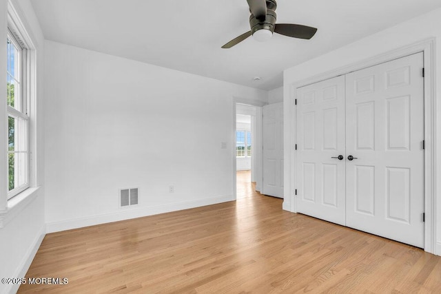27 Main St, Port Monmouth, NJ 07758 - unfurnished bedroom with light wood finished floors, baseboards, a closet, and a ceiling fan
