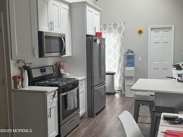 279 Washington St, Keyport, NJ 07735 - kitchen featuring appliances with stainless steel finishes, light countertops, dark wood finished floors, and tasteful backsplash