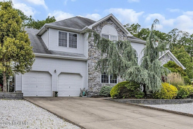 1771 Calico Ln, Toms River, NJ 08753 - view of front of home featuring stone siding, concrete driveway, roof with shingles, and a garage