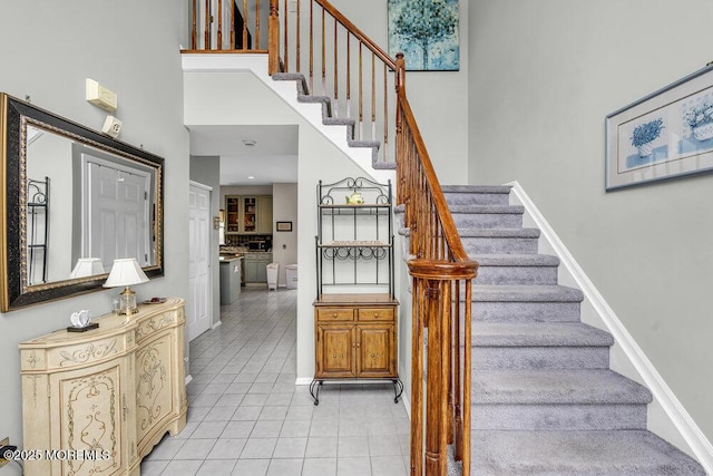 1771 Calico Ln, Toms River, NJ 08753 - stairs featuring a towering ceiling, tile patterned flooring, and baseboards