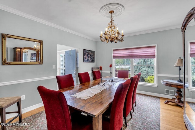 1771 Calico Ln, Toms River, NJ 08753 - dining room featuring a chandelier, wood finished floors, crown molding, and baseboards