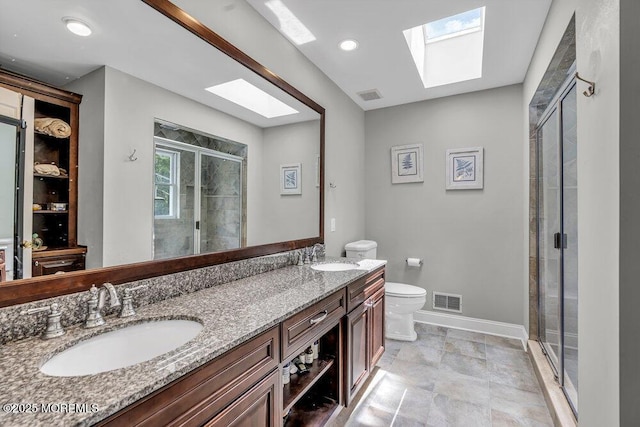 1771 Calico Ln, Toms River, NJ 08753 - bathroom featuring a skylight, toilet, a shower stall, double vanity, and baseboards