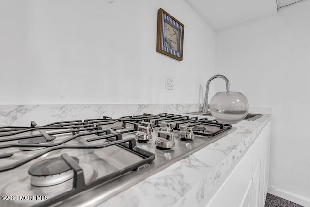 1771 Calico Ln, Toms River, NJ 08753 - kitchen view of stainless steel gas stovetop, light countertops, and white cabinetry