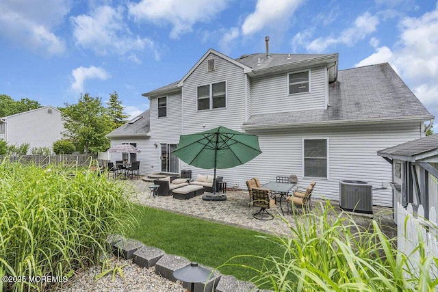 1771 Calico Ln, Toms River, NJ 08753 - rear view of property featuring central air condition unit, an outdoor hangout area, a patio area, and a shingled roof