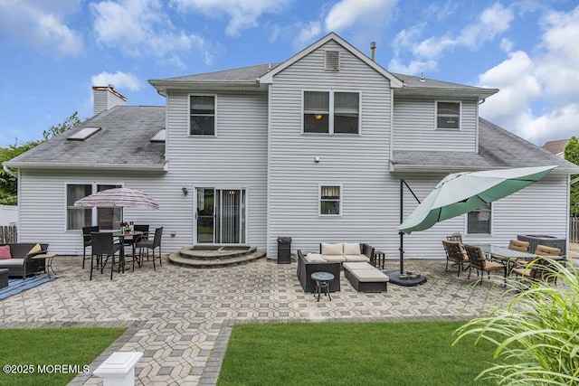 1771 Calico Ln, Toms River, NJ 08753 - back of property with an outdoor living space, a patio, roof with shingles, and a chimney