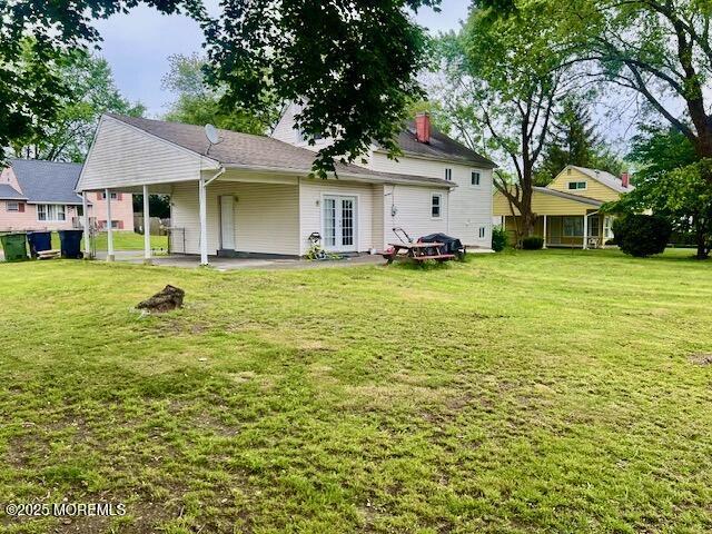 706 Tide Pl, Neptune Township, NJ 07753 - rear view of house with a patio area, a yard, and a chimney