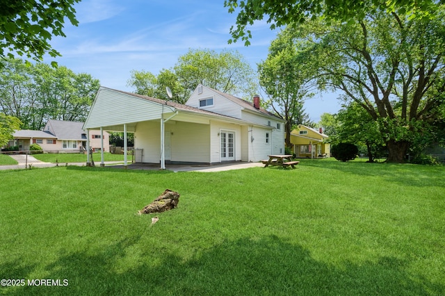 706 Tide Pl, Neptune Township, NJ 07753 - back of property with french doors, a yard, a chimney, and a patio