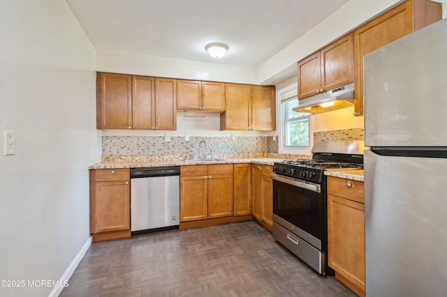 706 Tide Pl, Neptune Township, NJ 07753 - kitchen featuring appliances with stainless steel finishes, under cabinet range hood, decorative backsplash, and brown cabinets