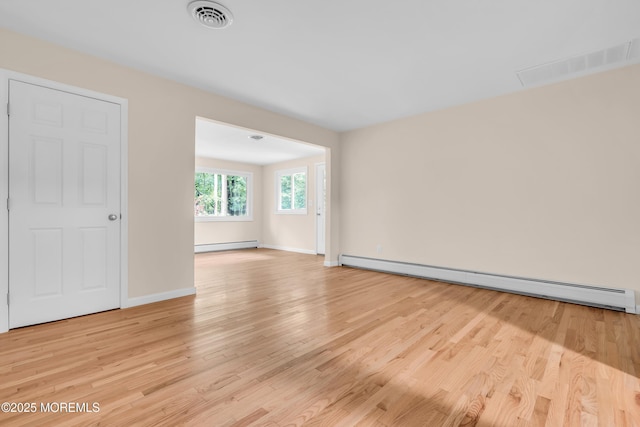 10D Heron St, Manchester, NJ 08759 - empty room with a baseboard heating unit, light wood-style floors, and baseboards