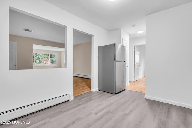 10D Heron St, Manchester, NJ 08759 - empty room with a baseboard radiator, wood finished floors, and baseboards