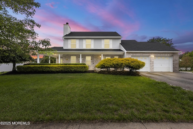 39 Sarah Ln, Howell, NJ 07731 - view of front of property featuring driveway, a chimney, a garage, a lawn, and brick siding