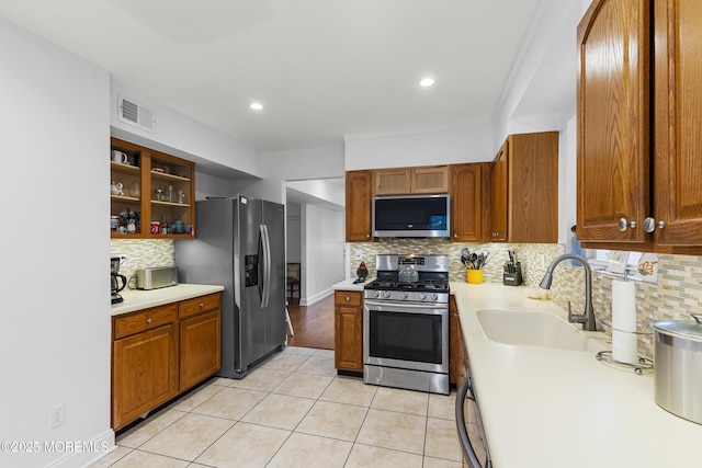 39 Sarah Ln, Howell, NJ 07731 - kitchen with stainless steel appliances, a sink, light countertops, tasteful backsplash, and light tile patterned flooring