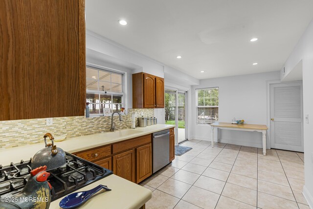 39 Sarah Ln, Howell, NJ 07731 - kitchen with dishwasher, a sink, backsplash, cooktop, and light countertops
