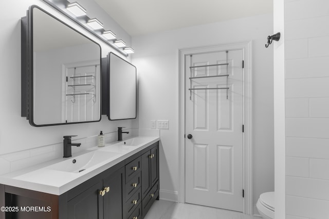 39 Sarah Ln, Howell, NJ 07731 - full bathroom with double vanity, toilet, tile patterned floors, and baseboards