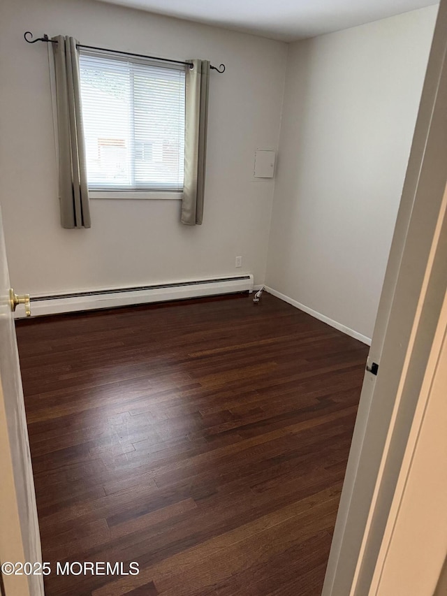 3B Blue Jay St, Manchester, NJ 08759 - spare room featuring a baseboard radiator, dark wood-type flooring, and baseboards