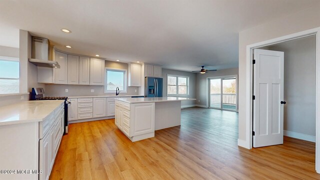 6 Lake Superior Dr, Little Egg Harbor, NJ 08087 - kitchen featuring wall chimney exhaust hood, stainless steel appliances, ceiling fan, light wood-type flooring, and recessed lighting