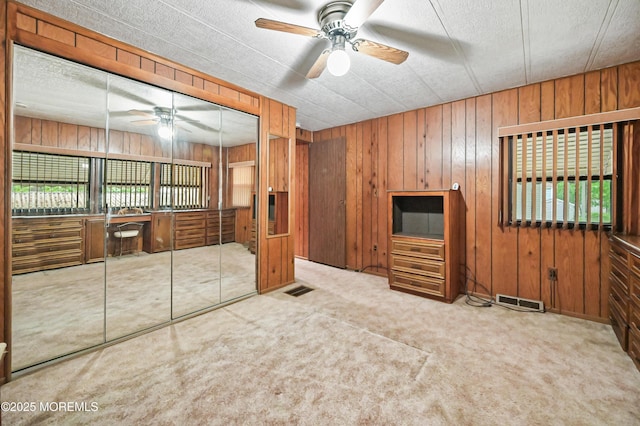 119 Village Rd, Morganville, NJ 07751 - unfurnished living room featuring carpet, a ceiling fan, and wooden walls