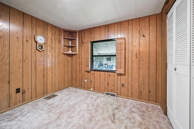 119 Village Rd, Morganville, NJ 07751 - empty room featuring wooden walls, carpet flooring, and baseboards