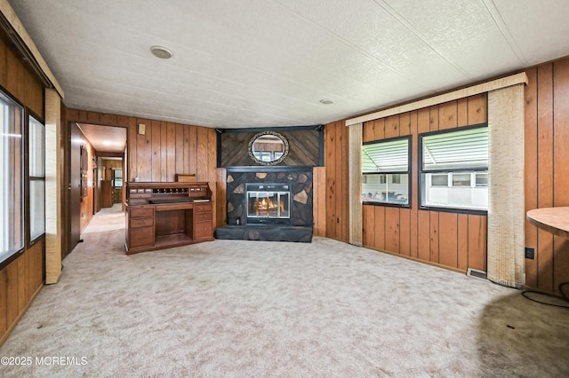 119 Village Rd, Morganville, NJ 07751 - unfurnished living room featuring wooden walls, plenty of natural light, carpet, and a fireplace