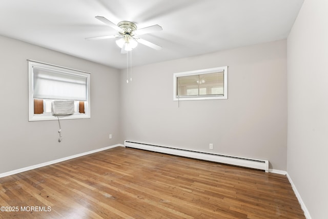 27 Cedar St Unit A, Toms River, NJ 08757 - spare room with a baseboard heating unit, ceiling fan, wood finished floors, and baseboards