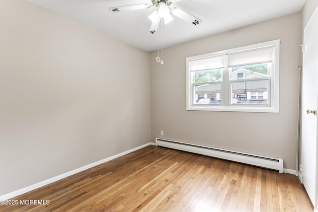 27 Cedar St Unit A, Toms River, NJ 08757 - unfurnished room featuring a baseboard heating unit, light wood-style flooring, baseboards, and a ceiling fan