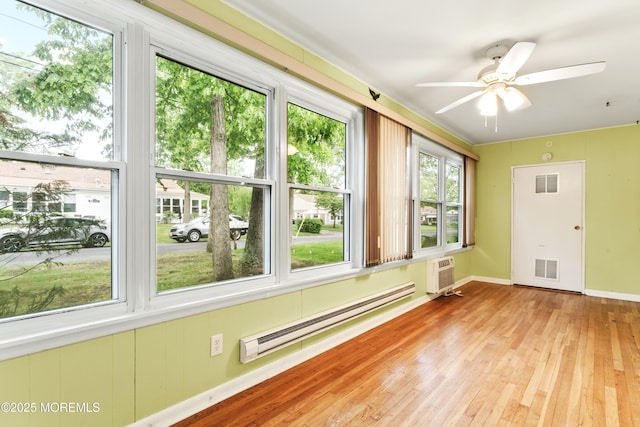 27 Cedar St Unit A, Toms River, NJ 08757 - unfurnished sunroom with a baseboard heating unit, hardwood / wood-style floors, an AC wall unit, and baseboards