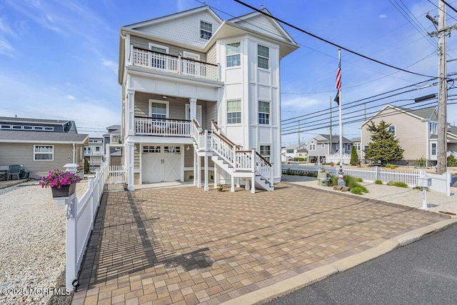 200 San Fernando Dr, Lavallette, NJ 08735 - view of front facade featuring a balcony, stairway, covered porch, a garage, and decorative driveway