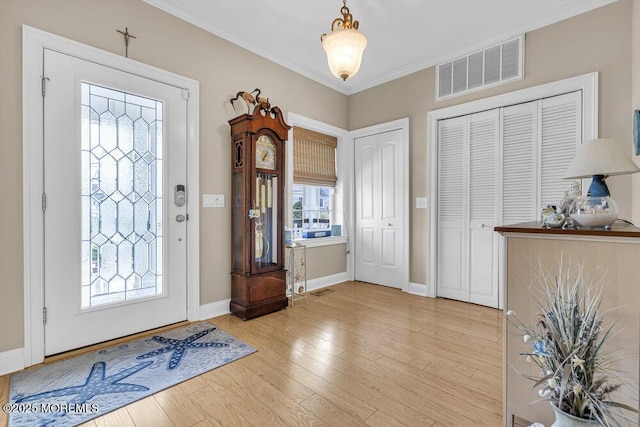 200 San Fernando Dr, Lavallette, NJ 08735 - entrance foyer featuring ornamental molding, baseboards, and light wood-style flooring