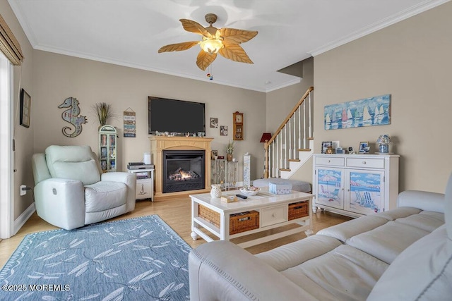 200 San Fernando Dr, Lavallette, NJ 08735 - living room with stairway, light wood-type flooring, ceiling fan, ornamental molding, and a glass covered fireplace