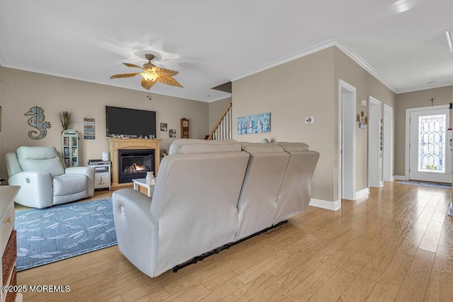 200 San Fernando Dr, Lavallette, NJ 08735 - living room featuring ceiling fan, light wood-style floors, a lit fireplace, baseboards, and ornamental molding