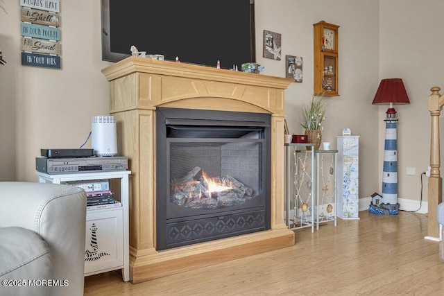 200 San Fernando Dr, Lavallette, NJ 08735 - detailed view of a lit fireplace, wood finished floors, and baseboards