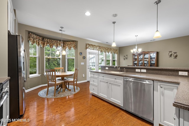 12 Stemson Ct, Little Egg Harbor, NJ 08087 - kitchen with appliances with stainless steel finishes, a sink, a chandelier, light wood finished floors, and white cabinetry