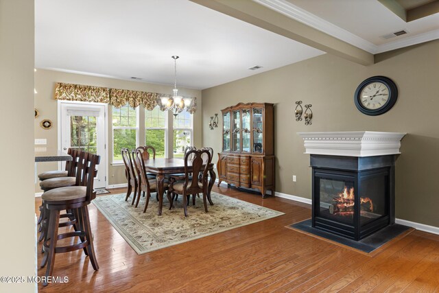 12 Stemson Ct, Little Egg Harbor, NJ 08087 - dining area with a chandelier, wood finished floors, baseboards, and a multi sided fireplace