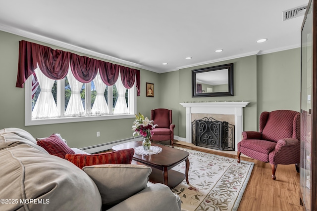 2 Miriam Dr, Matawan, NJ 07747 - living room featuring a baseboard heating unit, wood finished floors, ornamental molding, a premium fireplace, and recessed lighting