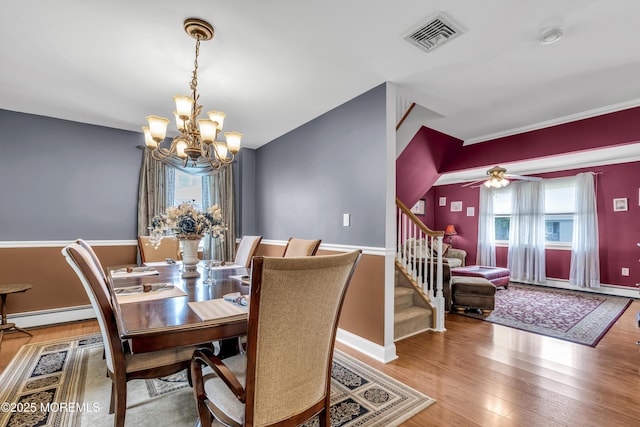 2 Miriam Dr, Matawan, NJ 07747 - dining space with a chandelier, wood finished floors, stairway, ceiling fan, and baseboard heating