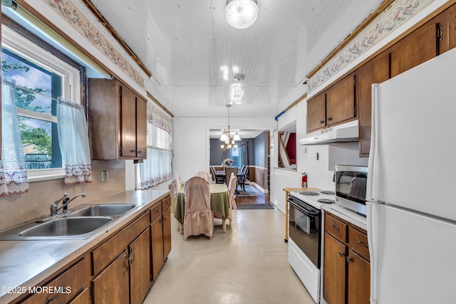 2 Miriam Dr, Matawan, NJ 07747 - kitchen featuring freestanding refrigerator, under cabinet range hood, a sink, electric stove, and light countertops