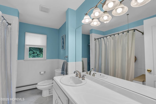 2 Miriam Dr, Matawan, NJ 07747 - bathroom with a baseboard heating unit, toilet, vanity, tile patterned floors, and wainscoting