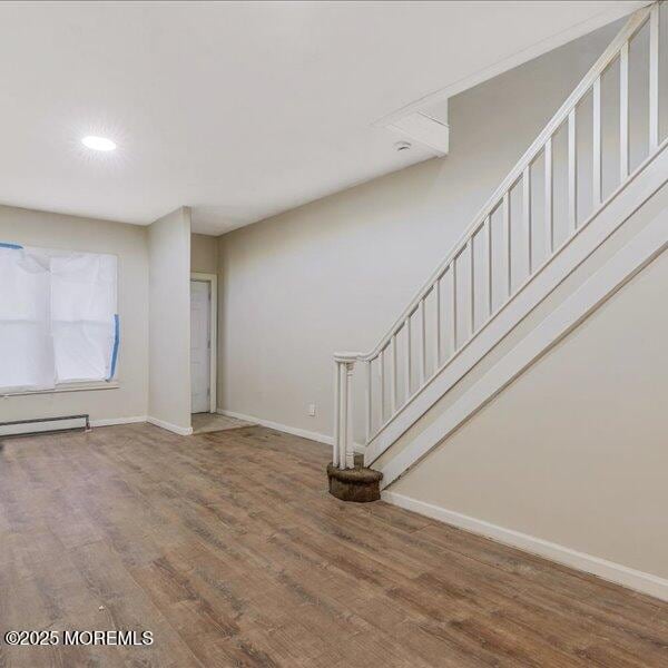 1262 Thurman St, Camden, NJ 08104 - unfurnished living room with baseboards, stairway, wood finished floors, a baseboard heating unit, and recessed lighting