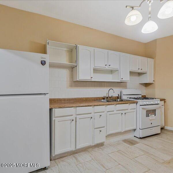 1262 Thurman St, Camden, NJ 08104 - kitchen featuring white appliances, a sink, white cabinets, and tasteful backsplash