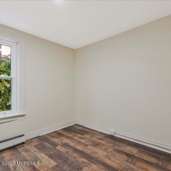 1262 Thurman St, Camden, NJ 08104 - unfurnished room featuring baseboard heating, dark wood-style floors, and baseboards