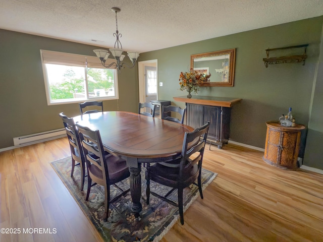 113 Boulder Lake Dr, Little Egg Harbor, NJ 08087 - dining area featuring a baseboard heating unit, a chandelier, a textured ceiling, light wood-style flooring, and baseboards