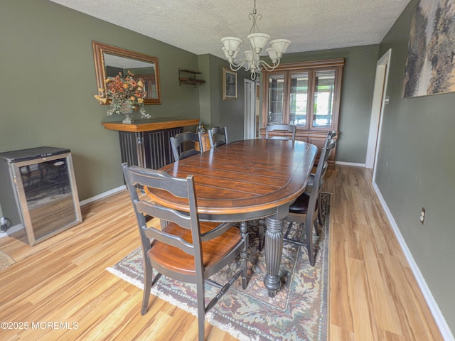 113 Boulder Lake Dr, Little Egg Harbor, NJ 08087 - dining space featuring a chandelier, a textured ceiling, wood finished floors, baseboards, and wine cooler