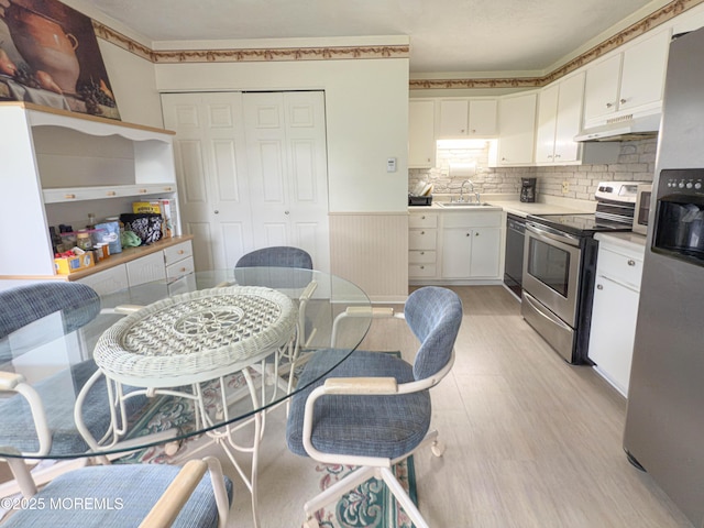 113 Boulder Lake Dr, Little Egg Harbor, NJ 08087 - kitchen with stainless steel electric range, under cabinet range hood, white cabinetry, light wood-type flooring, and dishwasher