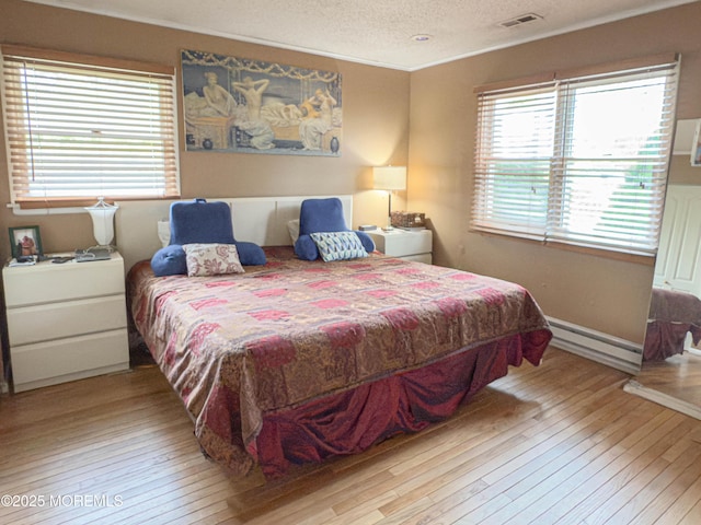 113 Boulder Lake Dr, Little Egg Harbor, NJ 08087 - bedroom with baseboard heating, wood-type flooring, crown molding, and a textured ceiling
