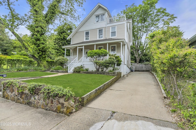75 Portland Rd, Highlands, NJ 07732 - view of front facade with covered porch, a front yard, and a balcony