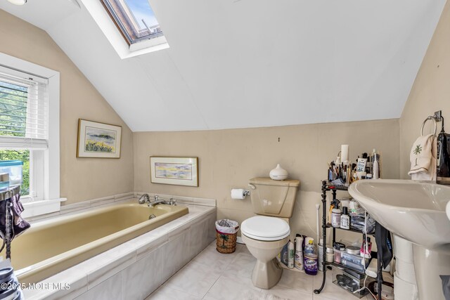 75 Portland Rd, Highlands, NJ 07732 - bathroom featuring lofted ceiling, a garden tub, and a skylight